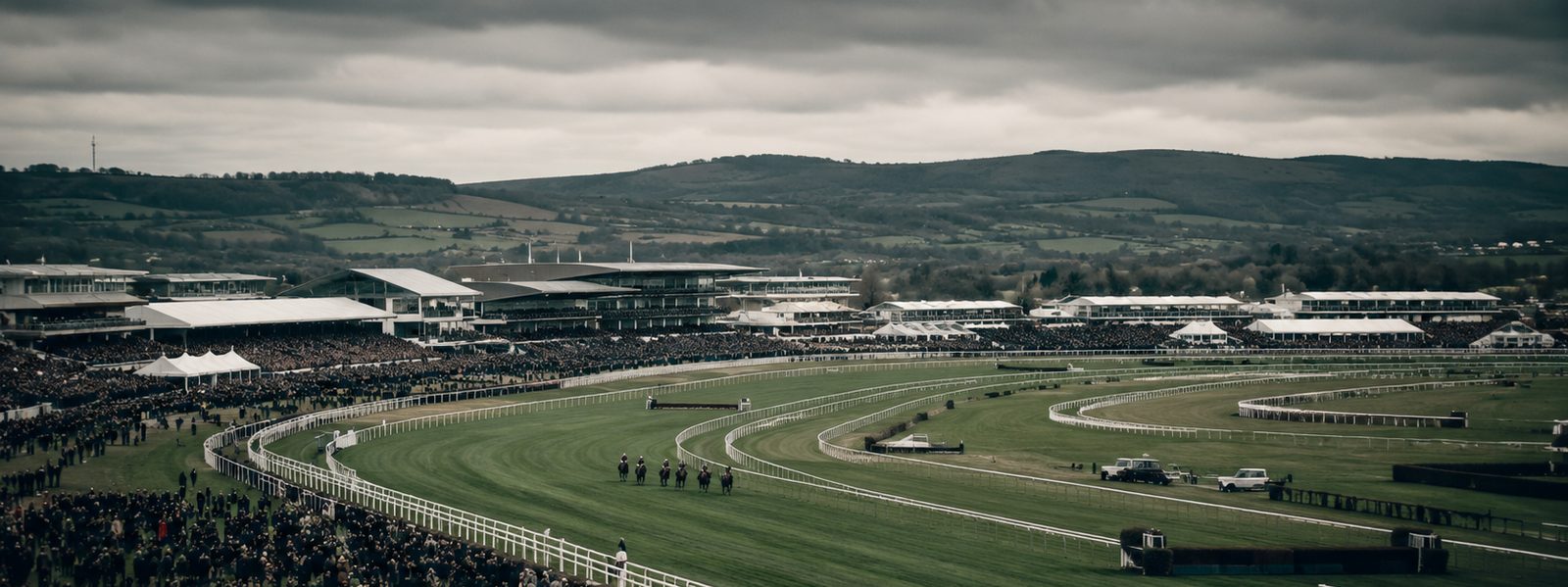 A wide view of a British racecourse and grandstands on raceday